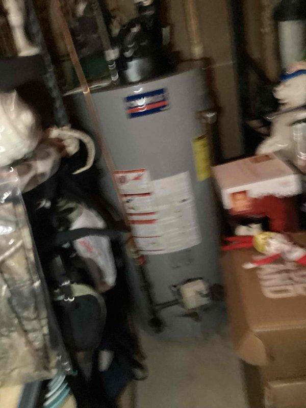 # Plumbing Inspection Service Report

Completed comprehensive plumbing system inspection of residential utility room. Inspection focused on water heater installation, distribution piping, and circulation equipment to assess overall system condition and identify any potential concerns.

## Primary Systems Inspected

**Water Heating System:** Examined residential water heater tank unit including all supply and discharge connections. Verified proper pipe connections at top of unit with copper and black piping configurations. Assessed tank exterior condition and manufacturer specifications visible on unit labeling.

**Plumbing Distribution Network:** Inspected vertical copper supply lines running along wall framing. Evaluated corrugated flexible copper connector lines with valve assemblies for proper installation and secure fittings. Checked all visible pipe runs throughout utility space for proper support and routing.

**Circulation Equipment:** Assessed pump assembly and associated valve