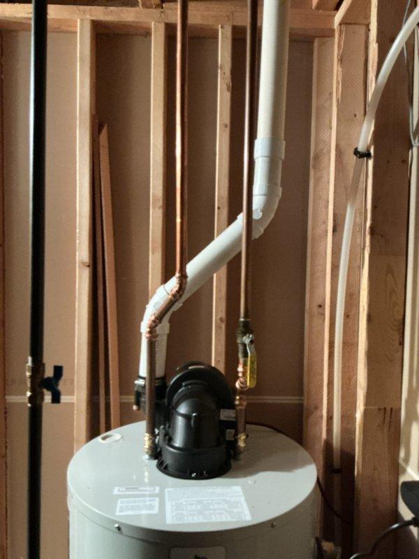 # Service Report: Water Heater Replacement

Responded to service call for leaking propane water heater. Upon arrival, confirmed active leak originating from bottom of existing unit, indicating tank failure. Diagnostic fee waived as replacement was clearly required.

Removed failed water heater and installed new 50-gallon power vent LP (propane) unit. Connected gas supply line with shutoff valve, installed proper venting system with PVC exhaust piping, and completed all water supply connections using copper piping. Verified proper electrical connections for power vent motor operation. Tested all connections for leaks and confirmed unit fired properly with adequate combustion and venting.

Per customer request, also removed old water softener system from premises. All removed equipment hauled away from property. Installation completed within scheduled service window. System operational and customer satisfied with completed work.