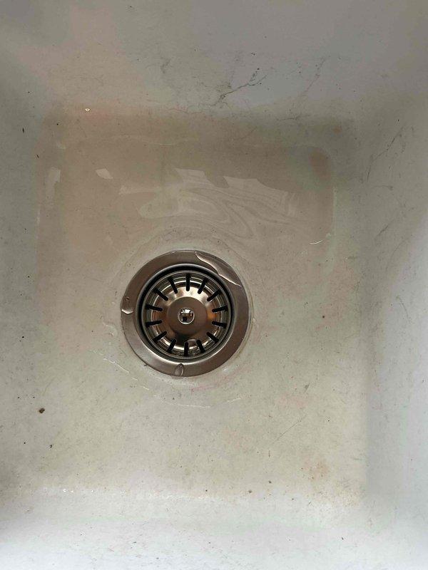 Responded to service call for bathroom sink drain issues including improper stopper operation and gurgling noises. Upon inspection, cleared lavatory drain that was heavily obstructed with accumulated hair buildup causing slow drainage. Additionally replaced worn kitchen basket strainer assembly per customer request. All fixtures tested and confirmed proper drainage function upon completion.