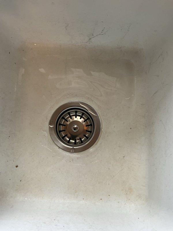 Responded to service call for bathroom sink drain issues including improper stopper operation and gurgling noises. Upon inspection, cleared lavatory drain that was heavily obstructed with accumulated hair buildup causing slow drainage. Additionally replaced worn kitchen basket strainer assembly per customer request. All fixtures tested and confirmed proper drainage function upon completion.