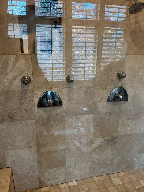 Responded to service call for shower experiencing lack of hot water. Upon arrival, confirmed thermostatic shower valve was not delivering hot water to the fixture. Customer had previously supplied replacement cartridge for the thermostatic mixing valve. Removed existing failed cartridge from the chrome-trimmed shower control valve and installed customer-provided replacement cartridge. Tested shower operation after installation to verify proper hot water delivery and temperature regulation. System restored to full functionality with appropriate hot water temperature now available at the dual shower system.