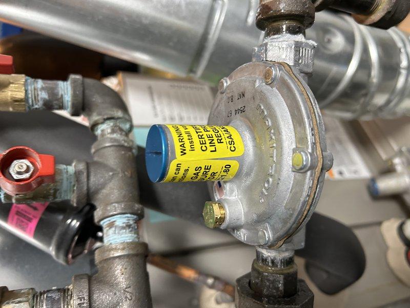 Responded to gas leak emergency after utility company shut off gas supply to residence due to leaking pressure regulator on gas line upstream of furnace. Performed diagnostic testing with combustible gas detector to verify leak location at regulator assembly. Replaced defective gas pressure regulator with new unit, including all associated fittings and connections. Pressure tested entire gas line system to ensure integrity of repair, confirmed no additional leaks present, and verified proper gas pressure at appliance. Coordinated with homeowner for site access and restored gas service upon successful completion of repairs and safety checks.