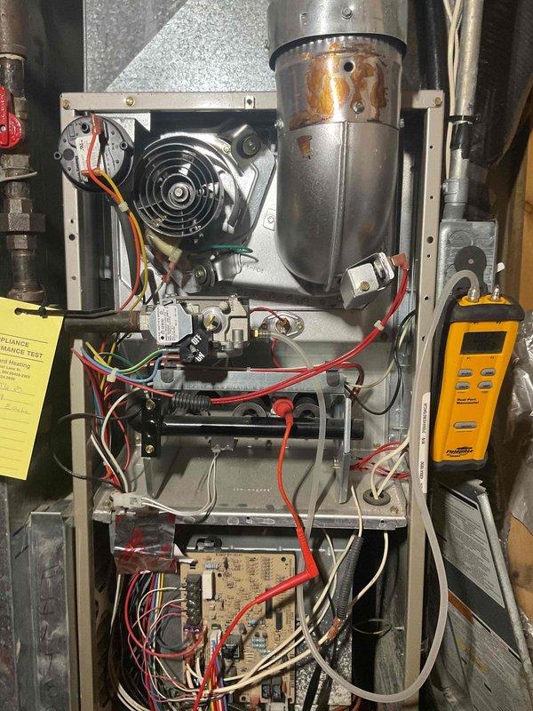 Completed annual furnace tune-up and preventive maintenance inspection on residential heating system. Performed comprehensive system diagnostics using digital testing equipment, inspected all internal components including blower motor assembly, heat exchanger, control board, and electrical connections. Heat exchanger examination revealed visible wear and early signs of deterioration with rust staining on flue pipe assembly, indicating unit is approaching end of service life. All electrical connections, wiring harnesses, and control circuits tested and found operational. Documented current system condition with photographic evidence showing component wear patterns. Advised customer that due to age of equipment and progressive heat exchanger deterioration, replacement should be considered in near future to avoid potential safety concerns and system failure during heating season.