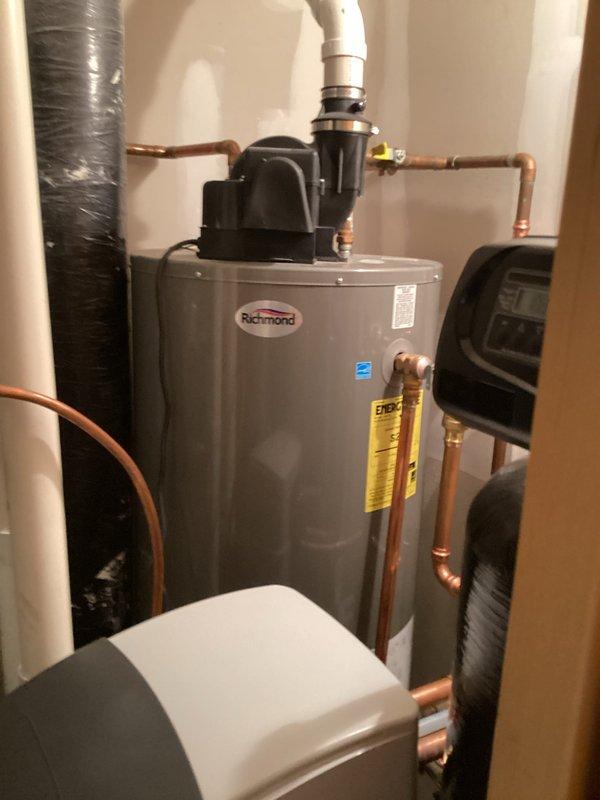 Responded to no hot water complaint following water softener installation. Upon arrival, diagnosed issue as power interruption to water heater system. Located blower motor switch in off position, preventing proper water heater operation. Restored power by switching blower motor to on position, which immediately restored hot water functionality. Verified Richmond tanked water heater returned to normal operation with proper heating cycle initiated. System tested and confirmed operational.