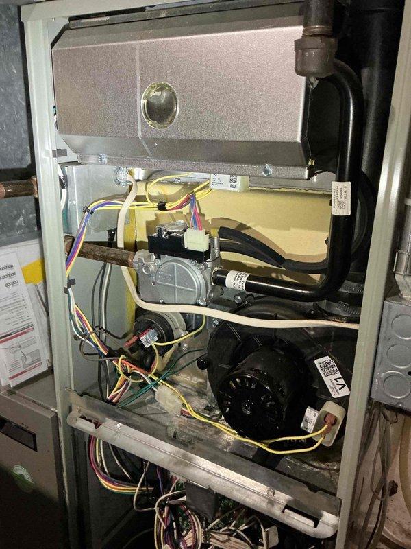 Responded to no-heat call on 15-year-old Trane furnace with reported humming noise from blower motor. Upon inspection, discovered heavily restricted MERV 12 air filter causing excessive static pressure, which forced the blower to ramp to high speed and created humming noise in ductwork. Replaced filter and confirmed noise elimination. 

Performed comprehensive system diagnostic including heat exchanger inspection using camera scope. Inspection revealed significant crack in heat exchanger located above factory crimp on lower burner cup section. Due to the critical safety hazard posed by potential carbon monoxide leakage into conditioned space, performed immediate safety lockout of equipment per industry protocol.

Documented findings with photographs of internal components including blower assembly, gas valve, control boards, and wiring configuration. Reviewed all available options with homeowner including repair versus replacement considerations. Completed manufacturer warranty researc