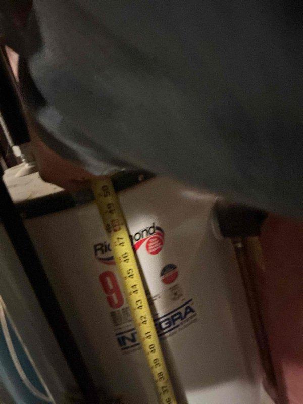 Responded to a water leak in the mechanical room, initially suspected to originate from either the water heater or water softener. Upon inspection, identified the source as a failed water heater tank with rust-through deterioration at the bottom, causing active water discharge onto the floor. Removed the compromised unit and installed a replacement Richmond Integra 40-gallon natural gas water heater with standard atmospheric venting to match the existing configuration. Completed all necessary connections including gas line, cold water supply, hot water distribution, temperature and pressure relief valve discharge piping, and exhaust venting. Verified proper operation, checked for leaks at all connection points, and confirmed adequate combustion and draft performance.