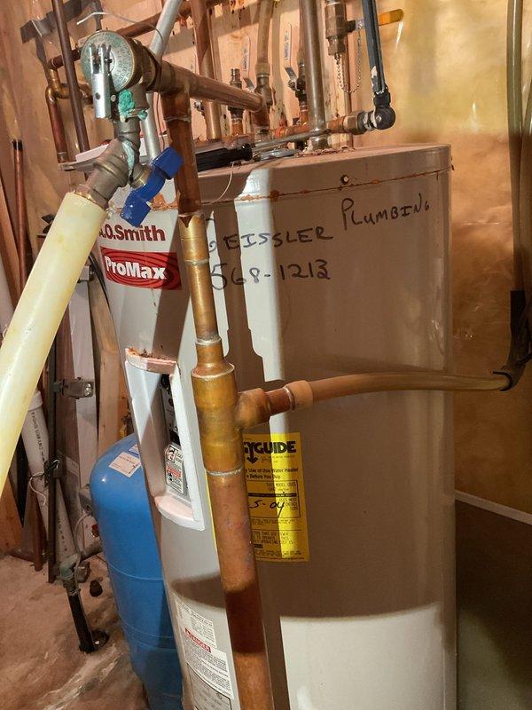 Performed comprehensive AC tune-up on system that had not been serviced in 4-5 years with no reported issues. Inspected all HVAC equipment including air conditioning unit, furnace, water heater, and Aprilaire humidifier, noting that all major equipment dates from 2004 and is nearing end of service life. Water heater shows significant deterioration and age-related wear, with visible corrosion and outdated plumbing connections requiring immediate attention for safety concerns. Discussed recommendations for replacing aging water heater and furnace due to equipment age and condition, as well as electrical panel upgrade needs to accommodate 220V sauna circuit with current 200-amp service at capacity. System operational at time of departure with advisement provided regarding prioritizing equipment replacements.