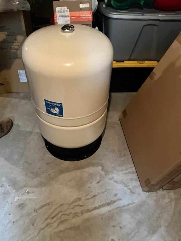 Responded to low water pressure complaint and diagnosed failed pressure tank. Removed and replaced defective pressure tank with customer-supplied unit. Installed new piping configuration with tee fitting and isolation valves to accommodate future expansion for potential second tank installation. System tested and restored to proper operating pressure upon completion.