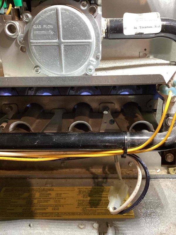 Responded to no heat call on Trane XL 80 furnace with blower operating but no ignition. Diagnosed faulty high limit switch stuck in open position, preventing burner operation despite receiving 24V control voltage. Replaced defective high limit switch and verified proper system operation with all safety controls functioning correctly.