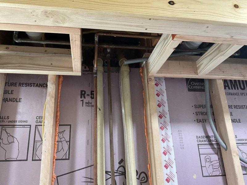 Provided comprehensive plumbing estimate for lower level laundry room installation, including rough-in specifications for waste line, two sets of hot and cold water supply lines with laundry hookup inserts, and gas line addition for range appliance. Assessed existing framing and insulation configuration to determine optimal routing for copper supply piping through wall cavities and proper waste line placement. Customer requested work to be scheduled for the following week upon estimate approval.