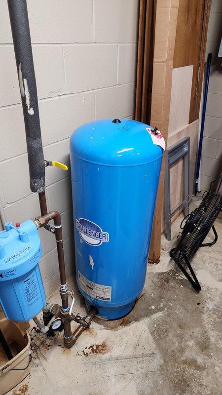 Responded to emergency water leak caused by burst 33-gallon expansion tank (Flexcon model PC122R) with failed bladder on main plumbing system. Water supply to residence was shut off upon arrival to prevent further damage.

Removed and replaced failed pressure tank with new Challenger brand expansion tank, including all necessary fittings and connections. Installed new effluent pump as requested. During system inspection, discovered malfunctioning water softener unit; removed softener from service and placed system on bypass to restore water flow.

Installed new Rusco whole house sediment filter system per homeowner request. Re-piped section of water supply lines adjacent to pressure tank location to accommodate removal of water softener unit and integration of new whole house filtration system. Reconfigured plumbing layout to ensure proper flow and access for future maintenance.

All new components tested and verified operational. System pressurized and checked for leaks. Water service