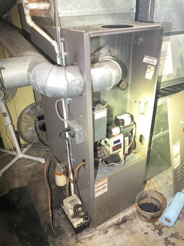 Responded to no heat call on oil-fired furnace experiencing short cycling and heavy soot accumulation. Upon inspection, discovered broken flame spreader had fallen in front of the nozzle, causing incomplete combustion and extensive sooting throughout the combustion chamber and heat exchanger. Also identified cracked pump solenoid valve requiring replacement. Documented equipment condition with photographs showing internal component damage and soot buildup. Compiled comprehensive parts list for pricing and submitted to parts department for quote on necessary repairs. Due to age of system and extent of repairs needed, coordinated with advisor to provide customer with comparison pricing for oil-to-gas conversion options as alternative solution to repair.