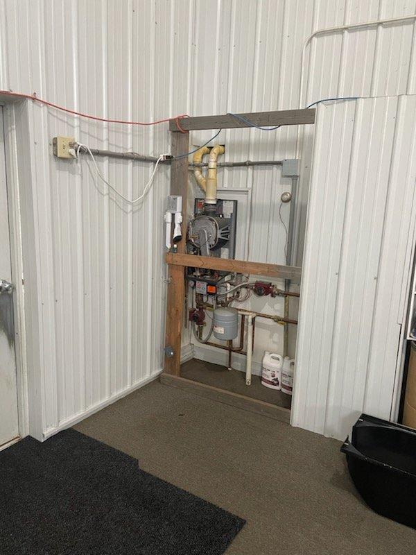 Responded to no heat call for gas boiler system located in barn/garage structure. Upon arrival, diagnosed boiler as non-operational due to low water condition. Filled system to proper operating level and verified all connections. Successfully restarted boiler unit, confirmed ignition sequence, and verified system returned to normal heating operation with proper circulation.