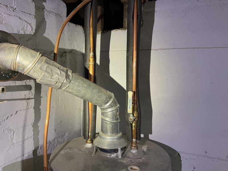 Responded to no hot water complaint on 11-year-old 40-gallon gas water heater producing only lukewarm water between 8am-12pm. Upon inspection, found unit with no pilot light and standard venting configuration. Given the age of the equipment and lack of hot water production, recommended complete water heater replacement as the most cost-effective solution.