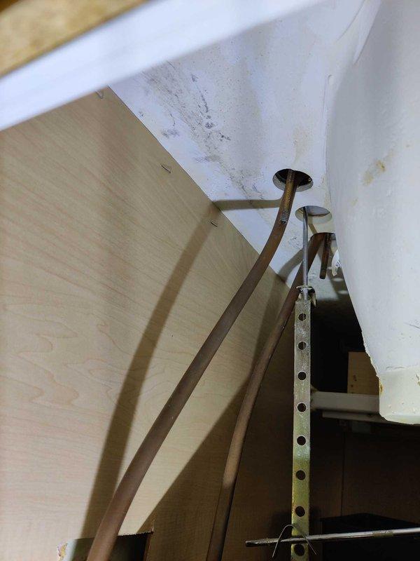 Conducted on-site plumbing estimate for installation of customer-supplied lavatory faucet in bathroom vanity. Assessed existing under-sink plumbing configuration including copper supply lines with chrome shut-off valves and P-trap drain assembly to determine installation requirements and compatibility with new fixture.