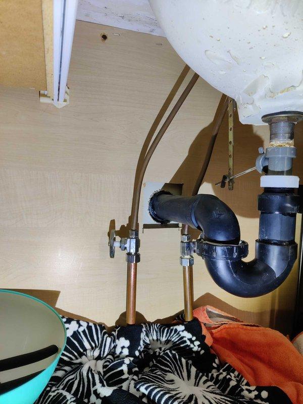 Conducted on-site plumbing estimate for installation of customer-supplied lavatory faucet in bathroom vanity. Assessed existing under-sink plumbing configuration including copper supply lines with chrome shut-off valves and P-trap drain assembly to determine installation requirements and compatibility with new fixture.