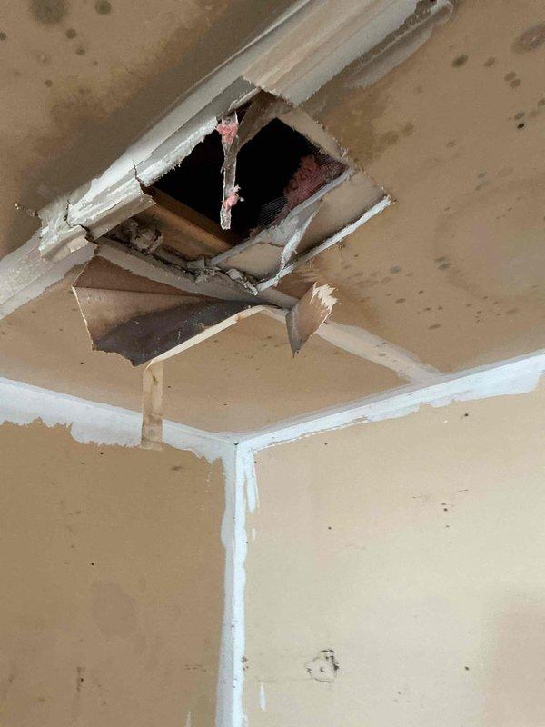 Responded to water leak emergency in garage with severely saturated ceiling showing significant sagging and structural compromise. Traced water source to failed dishwasher supply line in unit directly above the damaged garage ceiling. Coordinated with maintenance personnel for dishwasher replacement and installation of new supply line to eliminate leak source. Documented extensive ceiling damage including collapsed drywall sections, exposed framing, water staining, and deteriorated building materials requiring future restoration work.