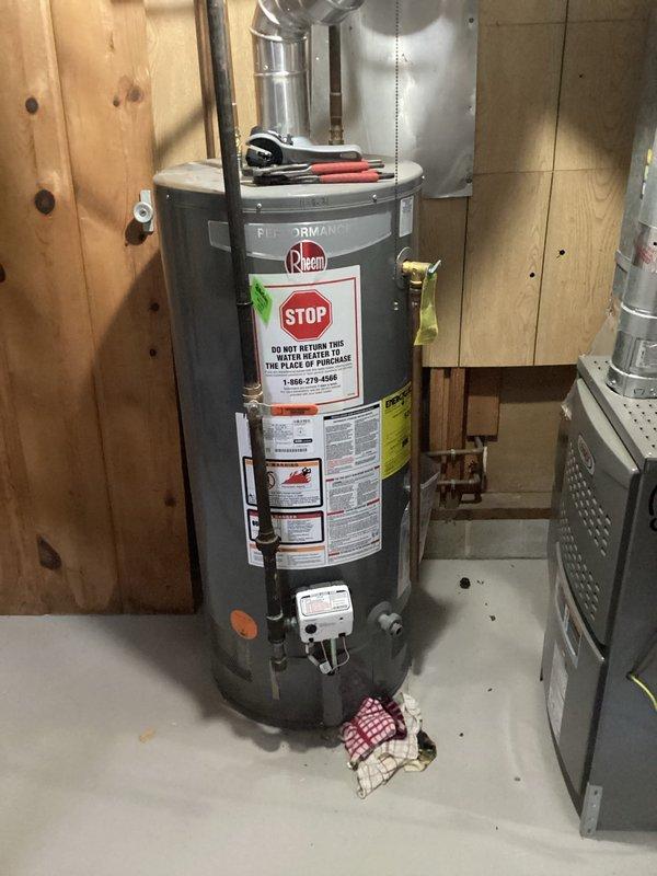 Responded to service call for natural gas water heater with tank leak. Assessed existing Rheem water heater in basement utility area and confirmed active tank leak requiring replacement. Provided estimate for installation of customer-supplied water heater unit. Customer indicated the failing unit is approximately 5 years old and plans to return it to point of purchase. Disconnection and removal of existing natural gas water heater to be scheduled once replacement unit is available on-site for immediate installation.