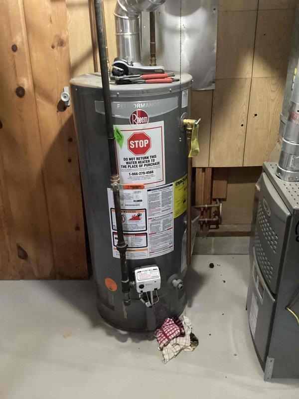 Responded to service call for natural gas water heater with tank leak. Assessed existing Rheem water heater in basement utility area and confirmed active tank leak requiring replacement. Provided estimate for installation of customer-supplied water heater unit. Customer indicated the failing unit is approximately 5 years old and plans to return it to point of purchase. Disconnection and removal of existing natural gas water heater to be scheduled once replacement unit is available on-site for immediate installation.