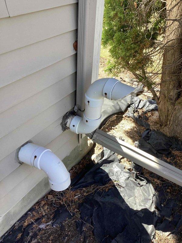 Completed install correction callback to address code compliance issue with furnace venting termination. Installed 3x2 PVC reducer and added approximately 8-inch length of 2-inch PVC pipe cut at 45-degree angle to reduce existing 3-inch vent termination to required 2-inch diameter at exterior discharge point per local code requirements.