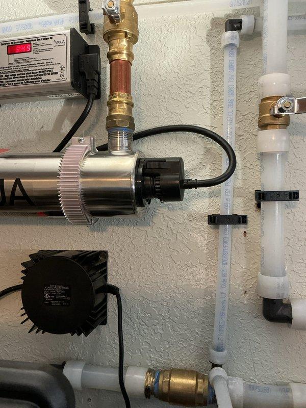 Responded to a leak issue on a recently installed UV water treatment system. Upon arrival, identified water leaking from both end caps of the UV light chamber assembly. Tightened both compression caps on the UV tube housing to proper torque specifications. Restored water supply to the system and monitored all connections for ten minutes to verify complete leak elimination and proper system operation.
