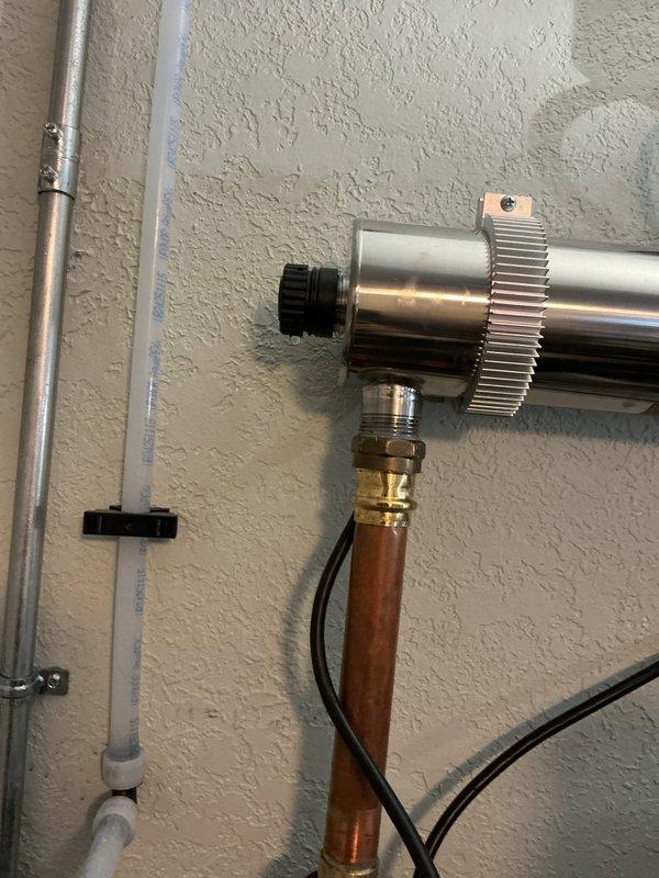 Responded to a leak issue on a recently installed UV water treatment system. Upon arrival, identified water leaking from both end caps of the UV light chamber assembly. Tightened both compression caps on the UV tube housing to proper torque specifications. Restored water supply to the system and monitored all connections for ten minutes to verify complete leak elimination and proper system operation.