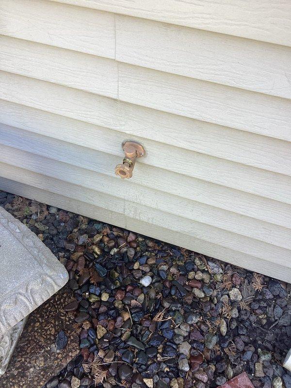 Responded to a leaking outdoor hose bibb that required the interior water supply to be shut off to prevent continuous water discharge. Accessed the supply line through an interior wall cavity, removed the failed hose bibb, and installed a new copper hose bibb assembly on the exterior siding. Restored water supply and verified proper operation with no leaks detected at the connection point.