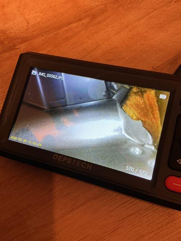 Responded to no heat call on 17-year-old Carrier 80% efficiency furnace. Upon arrival, performed system evaluation and diagnostics to determine cause of heating failure. Utilized inspection camera equipment to assess internal components and ductwork condition. 

During diagnostic process, identified seized blower motor as primary failure point preventing system operation. Documented significant access limitations due to installation configuration - unit located in confined closet space with stackable washer/dryer combo positioned directly in front of furnace, preventing adequate clearance for service or repair work. Current installation does not provide sufficient access to service panels or blower compartment.

Photographed equipment labels, installation conditions, and utilized borescope inspection camera to document internal component condition given limited physical access to unit. Captured images of ductwork and mechanical components for assessment documentation.

Informed propert