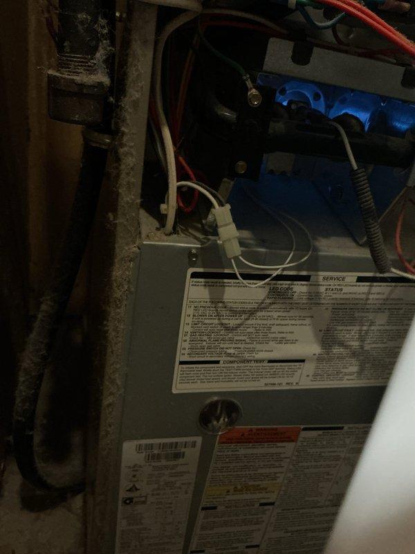 Responded to no heat call on 17-year-old Carrier 80% efficiency furnace. Upon arrival, performed system evaluation and diagnostics to determine cause of heating failure. Utilized inspection camera equipment to assess internal components and ductwork condition. 

During diagnostic process, identified seized blower motor as primary failure point preventing system operation. Documented significant access limitations due to installation configuration - unit located in confined closet space with stackable washer/dryer combo positioned directly in front of furnace, preventing adequate clearance for service or repair work. Current installation does not provide sufficient access to service panels or blower compartment.

Photographed equipment labels, installation conditions, and utilized borescope inspection camera to document internal component condition given limited physical access to unit. Captured images of ductwork and mechanical components for assessment documentation.

Informed propert