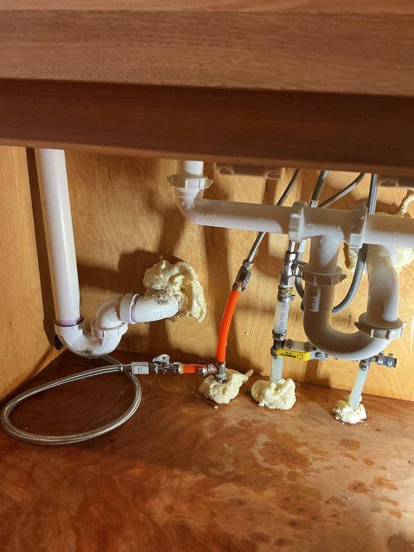 Responded to a dual plumbing issue involving a leaking Delta shower valve and a clogged kitchen sink drain. Upon inspection, found the shower valve cartridge was failing and causing water to leak from the handle. Replaced the Delta cartridge to restore proper function and eliminate the leak.

For the kitchen sink, diagnosed a grease blockage in the horizontal drain section before the vertical drop. The homeowner had previously attempted to clear the obstruction and noted a gel-like substance in the pipes. Used a drain auger to break up the grease accumulation, then employed a blow bag to fully clear the line and restore proper drainage. The blockage was successfully removed from the accessible horizontal pipe section without requiring extensive disassembly of the drain system.