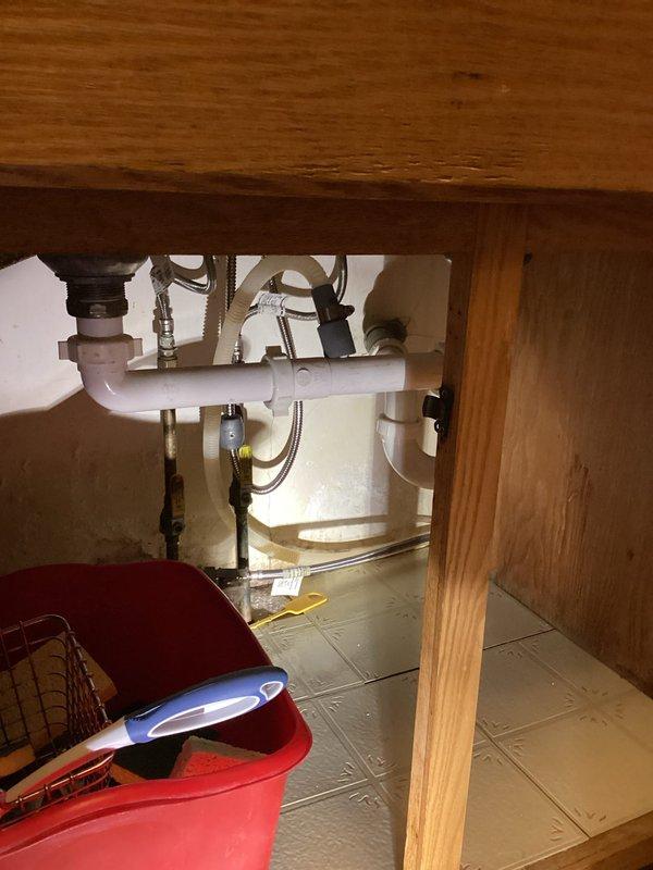 Conducted on-site evaluation for garbage disposal installation at residential property. Assessed existing under-sink plumbing configuration, which currently features standard P-trap assembly with white PVC drain lines and chrome shut-off valves connected to braided stainless steel supply lines. Inspected cabinet space dimensions and clearances to determine feasibility of garbage disposal unit installation. Reviewed electrical infrastructure in basement area, noting proximity of existing electrical panel and available circuit capacity for powering disposal unit. Documented current plumbing setup and structural conditions through photographic documentation to provide accurate installation estimate.