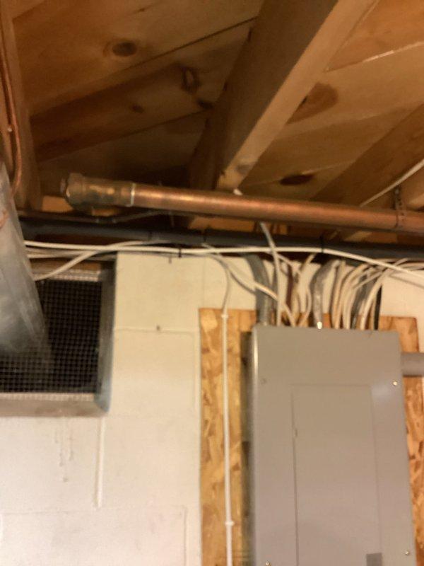 Conducted on-site evaluation for garbage disposal installation at residential property. Assessed existing under-sink plumbing configuration, which currently features standard P-trap assembly with white PVC drain lines and chrome shut-off valves connected to braided stainless steel supply lines. Inspected cabinet space dimensions and clearances to determine feasibility of garbage disposal unit installation. Reviewed electrical infrastructure in basement area, noting proximity of existing electrical panel and available circuit capacity for powering disposal unit. Documented current plumbing setup and structural conditions through photographic documentation to provide accurate installation estimate.