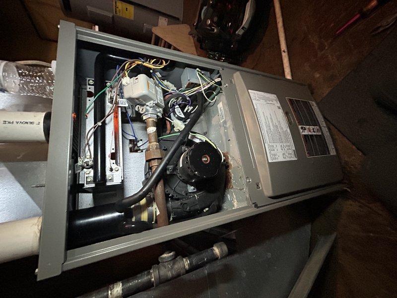 Responded to no heat call and investigated reported water accumulation near furnace in basement. Performed thorough inspection of furnace cabinet and internal components, finding interior completely dry with only minor condensate dripping from inducer motor into top cabinet. Determined furnace was not the source of water issue based on minimal recent operation due to warm weather and lack of moisture inside unit. Customer reported heavy water usage prior to discovering basement moisture and indicated history of groundwater intrusion during heavy rain events. Noted absence of sump pump system in older basement construction. Unable to perform water flow testing due to municipal water service interruption on street. Assessed situation and concluded water infiltration likely originating from groundwater seepage rather than HVAC system malfunction. Documented findings with photographs and recommended plumbing service to address basement water concerns and potential drainage issues.