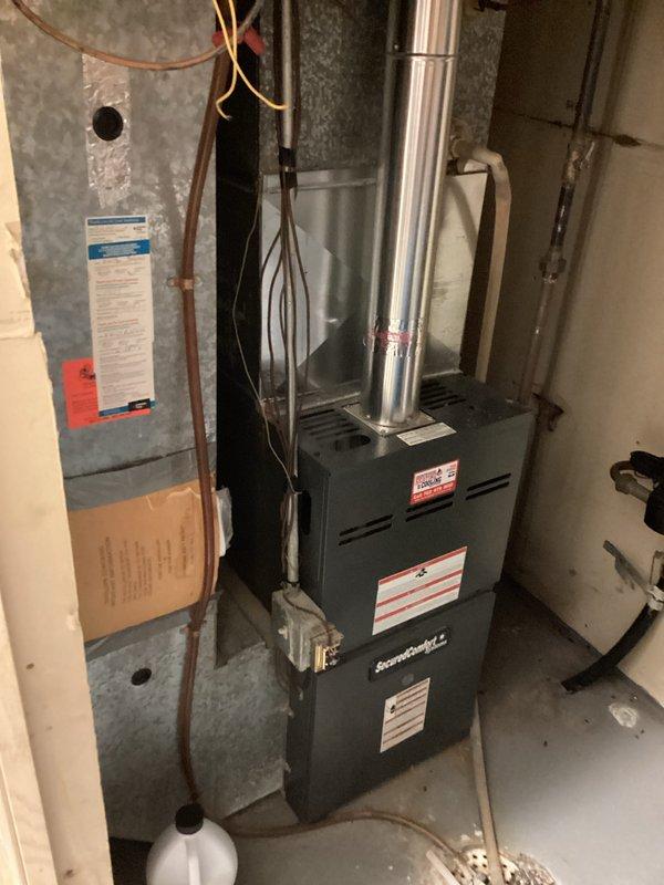 Responded to service call for non-functioning washing machine valve that would not turn due to age-related deterioration. Assessed valve condition and provided estimate for replacement of either the single faulty hot water valve or both valves as a preventative measure. Documented existing plumbing configuration in basement utility area, including water heater connections, copper piping, and associated fixtures to determine scope of valve replacement work required.
