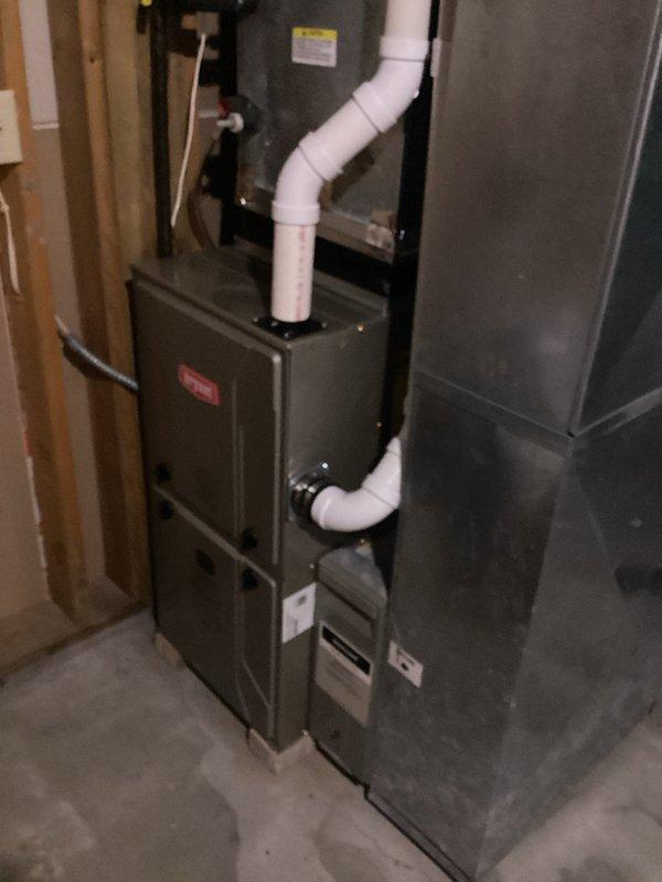 Responded to warranty call for loud noise from Bradford White water heater audible throughout home. Diagnosed vibration originating from unsecured PVC venting in finished soffit rather than blower motor assembly. Verified blower motor operation within normal parameters. Homeowner declined recommendation to open soffit for proper venting securement. Documented existing conditions with photos showing water heater installation, venting configuration, and surrounding mechanical systems.