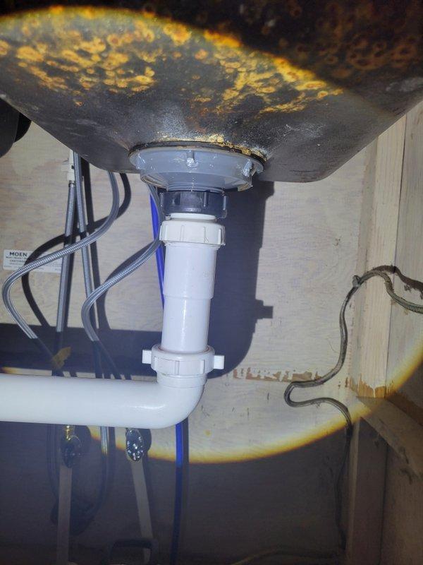 Responded to a water leak at the kitchen sink caused by a failing basket strainer at the right basin. Upon inspection, found the existing basket strainer was old and deteriorated, resulting in active leaking beneath the sink. Removed the defective basket strainer assembly and installed a new replacement unit. Tested the drain system for proper sealing and verified no further leaks were present upon completion.