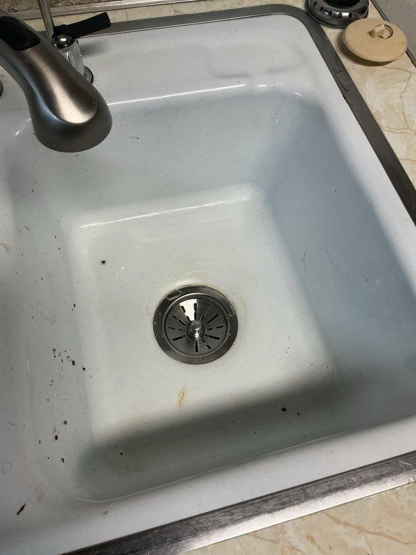 Responded to a water leak at the kitchen sink caused by a failing basket strainer at the right basin. Upon inspection, found the existing basket strainer was old and deteriorated, resulting in active leaking beneath the sink. Removed the defective basket strainer assembly and installed a new replacement unit. Tested the drain system for proper sealing and verified no further leaks were present upon completion.