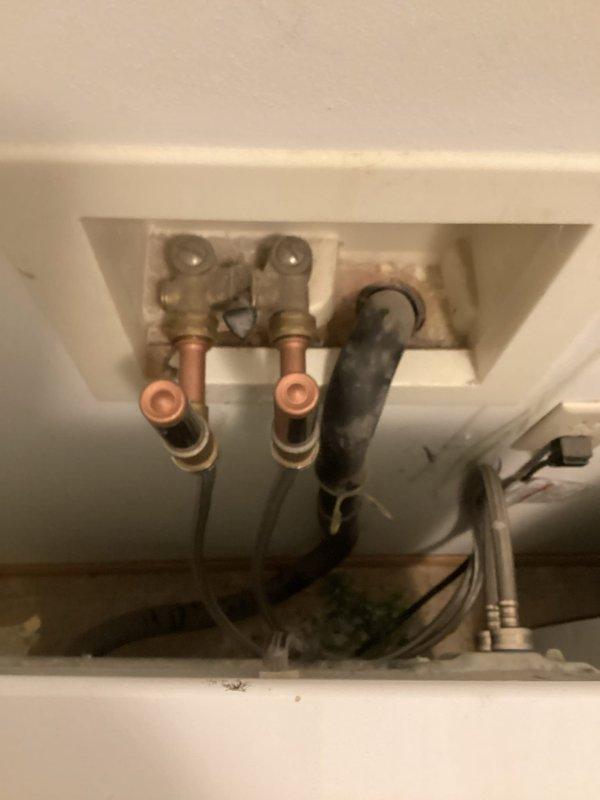 Repaired leak on 1/2" copper tubing located behind water heater by cutting out damaged section and installing new copper piping with proper compression fittings. Replaced deteriorated washing machine supply hoses on second floor laundry connection with new stainless steel braided hoses. Installed shock arrestors on hot and cold water lines serving washing machine to eliminate water hammer and protect plumbing system from pressure spikes. Replaced faulty water supply piping at washing machine connection point, ensuring all connections were properly secured and leak-free. All repairs tested under full pressure and verified operational.