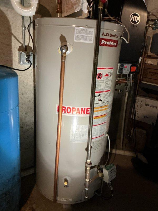 Responded to service call for A.O. Smith propane water heater not maintaining consistent temperature and requiring frequent manual resets over the past month. Upon inspection, retrieved error code from unit and contacted technical support for diagnostic confirmation. Technical support determined the gas valve had failed and required replacement. Presented customer with repair versus replacement options, including costs for new gas valve installation versus complete water heater replacement. Customer elected to proceed with full water heater replacement rather than repair. Successfully removed existing A.O. Smith ProMax propane water heater and installed new replacement unit. Connected all copper supply and discharge piping, verified proper gas line connections, and ensured integration with existing htp heating system and pressure tank. Tested new water heater for proper operation, temperature settings, and verified no gas leaks at connections. System now providing consistent hot water 
