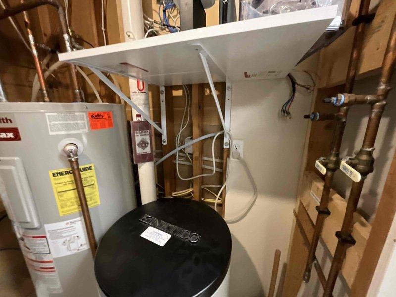 Responded to service call for 50-gallon electric water heater experiencing heating failure after approximately 15 minutes of use. Upon inspection, confirmed 17-year-old unit was no longer maintaining consistent hot water supply due to age-related component failure. Evaluated existing installation in mechanical room including water treatment system, copper supply lines, and electrical connections. Provided detailed estimate for complete water heater replacement including removal of existing unit, installation of new 50-gallon electric water heater with appropriate code-compliant connections, and disposal of old equipment.