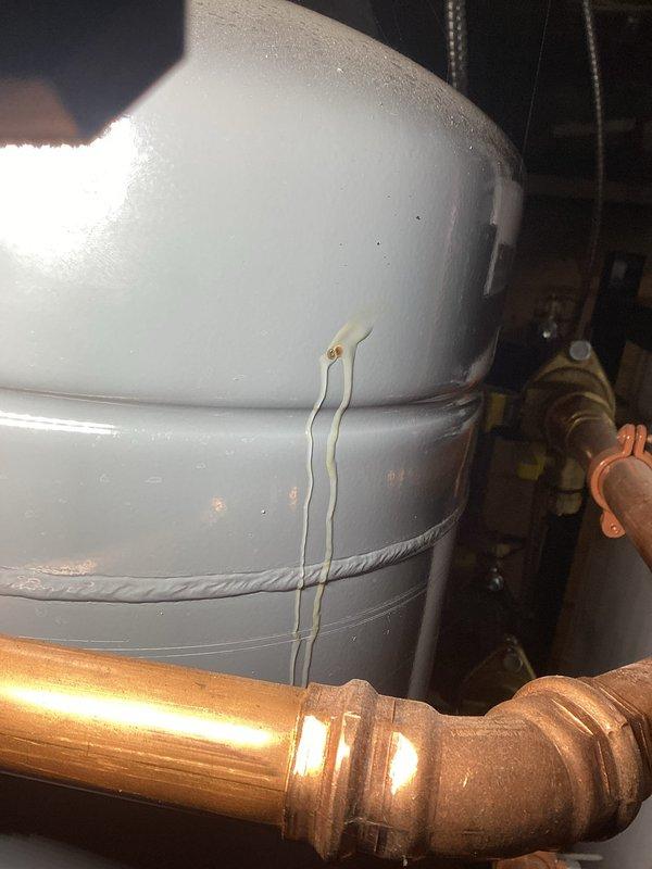 Responded to ongoing boiler leak that had been previously addressed by tightening valve handles. Upon inspection, discovered a pinhole leak above the bladder on the side of the expansion tank. Diagnosed failed expansion tank as the source of the recurring leak issue. Provided estimate for expansion tank replacement and collected partial payment. Scheduled return visit to install new expansion tank and complete the repair.