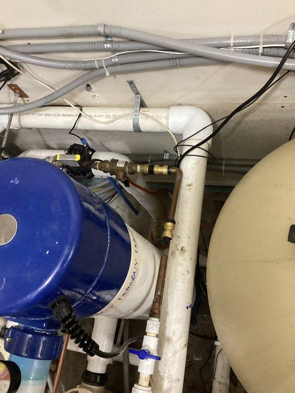 Responded to emergency leak on pool boiler system where a 1/2" copper feed line downstream of Watts 9D backflow preventer had failed due to a compromised SharkBite coupling that blew apart. Removed the failed push-fit coupling and replaced the affected section with rigid copper pipe and soldered connections to ensure a permanent, code-compliant repair. System was pressure tested, verified leak-free, and restored to full operation.