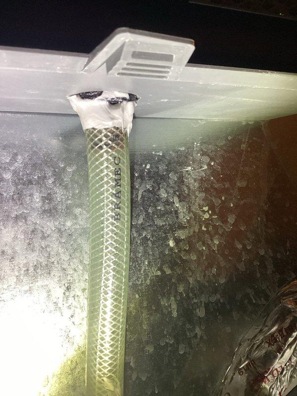 Responded to callback for reported Aprilaire humidifier leak. Upon arrival, unit was shut down per previous visit instructions. Reactivated humidifier and monitored operation for 30+ minutes with no leakage observed during test period. Assessed potential causes including water flow rate setting, which may have been set too high causing distribution tray overflow. Flushed drain line to ensure proper drainage. Inspected unit leveling and found slight left pitch, but within acceptable tolerance and not contributing to leak issue. Noted previous silicone application on drain spud by another contractor, though connection showed no active leaking. Advised leaving water adjustment at current reduced setting. Recommended full humidifier replacement if leaking recurs rather than incremental part replacement.