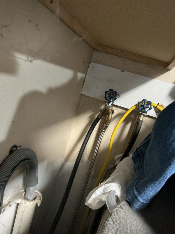 Completed comprehensive plumbing inspection of residential property as part of family rewards program. Inspected all visible plumbing components including under-sink fixtures, supply lines, shut-off valves, drain assemblies, and water heater. All plumbing systems found to be functioning properly with no active leaks or immediate concerns noted. Water supply lines with braided metal exteriors and blue-handled shut-off valves connected to copper pipe stubs were in good condition. PVC drain assemblies and P-trap configurations were secure and properly installed. However, water heater was identified as significantly aged and nearing end of service life. Documented findings with photographs of plumbing infrastructure and provided estimate for water heater replacement upon customer request.