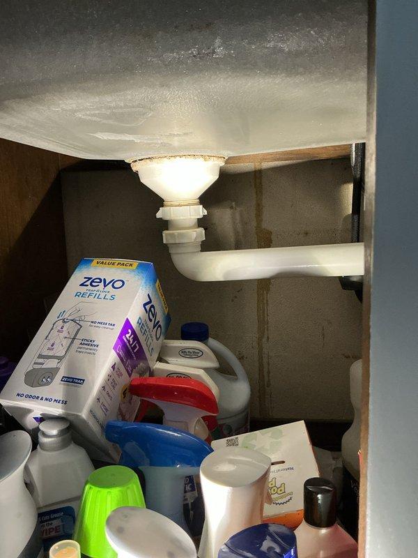 Completed comprehensive plumbing inspection of residential property as part of family rewards program. Inspected all visible plumbing components including under-sink fixtures, supply lines, shut-off valves, drain assemblies, and water heater. All plumbing systems found to be functioning properly with no active leaks or immediate concerns noted. Water supply lines with braided metal exteriors and blue-handled shut-off valves connected to copper pipe stubs were in good condition. PVC drain assemblies and P-trap configurations were secure and properly installed. However, water heater was identified as significantly aged and nearing end of service life. Documented findings with photographs of plumbing infrastructure and provided estimate for water heater replacement upon customer request.