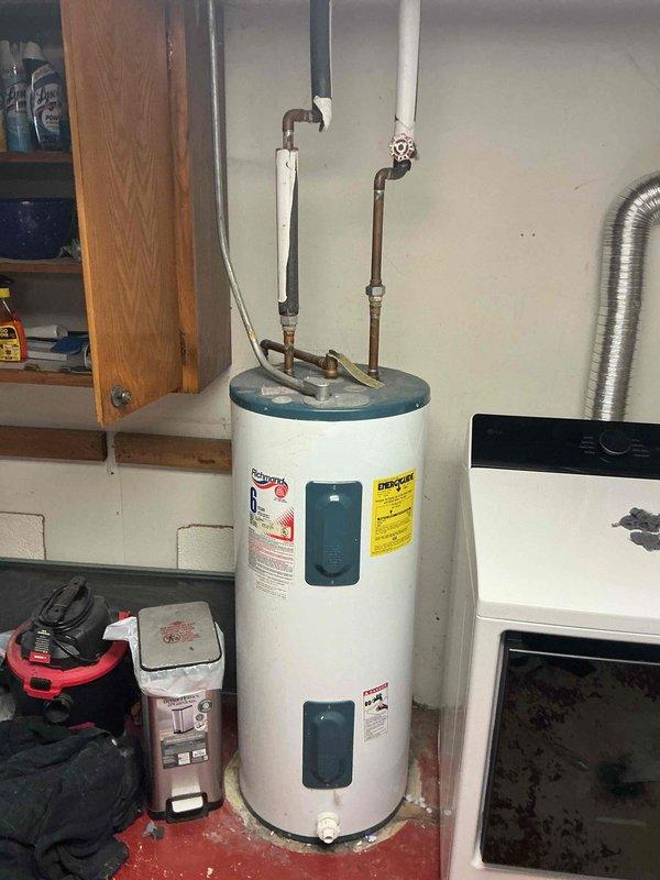 Completed comprehensive plumbing inspection of residential property with homeowner absent. Evaluated multiple fixtures and systems throughout the home, identifying several aging components including kitchen sink plumbing with older PVC P-trap configuration and discolored copper supply lines with shut-off valves, as well as a white cylindrical water heater showing signs of age with standard copper piping connections. Documented conditions via photographs and prepared replacement estimates for outdated fixtures and appliances requiring updating.