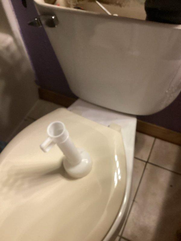 Responded to service call for continuously running toilet. Upon inspection, discovered loose flush valve assembly under tank causing leak, along with faulty ball cock mechanism. Replaced complete flush valve assembly, ball cock fill valve, and flush handle to resolve running water issue. Significant water accumulation observed on bathroom floor, attributed to combination of prolonged toilet operation, tank condensation, and leaking tank bolts—pre-existing conditions prior to service arrival. All components tested and functioning properly upon completion.