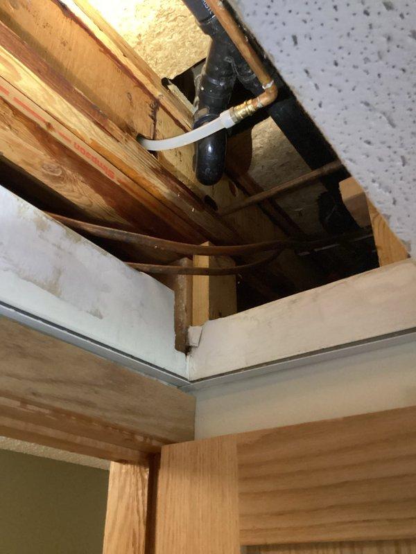 Responded to a ceiling water leak emergency and shut off the main water supply to the home to prevent further damage. Investigated the bathroom area but initially could not locate the source of the leak from below. Created ceiling access point to inspect the plumbing system above. Discovered a pinhole leak in the copper supply line feeding the shower valve. Removed the compromised section of copper piping and installed new copper supply line to the shower valve, restoring proper water flow and eliminating the leak.