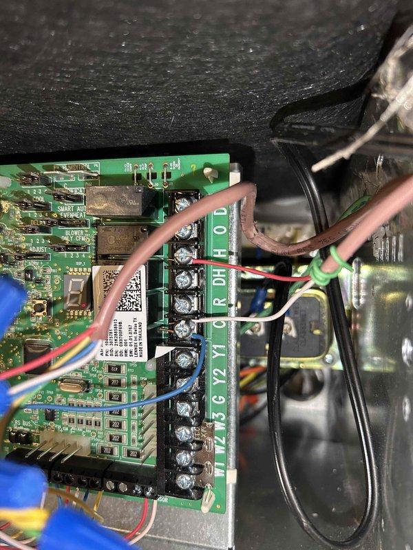 Return visit to establish connectivity between S40 thermostat and mobile app following previous system installation. Successfully connected thermostat to customer's phone app and verified full system operation remotely through the application, confirming all HVAC functions were responding properly as previously set up. Addressed customer concerns from provided checklist including humidifier wiring configuration, thermostat humidity and temperature calibration verification, and air handler performance assessment. Reviewed customer's request for additional relay installation on humidifier control but determined existing thermostat control board already provides necessary functionality for proper humidifier operation, negating need for additional components. Confirmed all wiring connections at control board including Y, G2, Y2, W, C, R, DH terminals were properly terminated and functioning. Discussed ductwork noise concerns related to air handler operation and verified system sizing compa