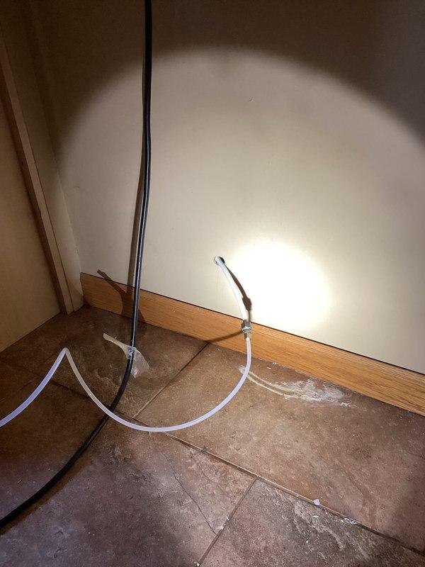 Responded to callback for water leak that developed after initial departure. Upon return, diagnosed leak originating from refrigerator water supply line. Removed failed refrigerator hose and installed new plastic tubing water line. Tested refrigerator operation and verified all connections were secure with no active leaks present.